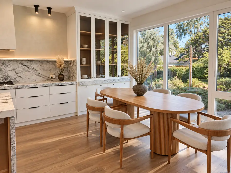 Kitchen: The run and the glass-front uppers, dining beyond