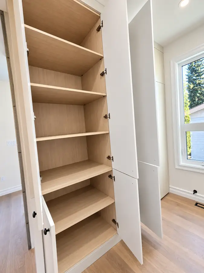 Kitchen: Tall storage run, doors open