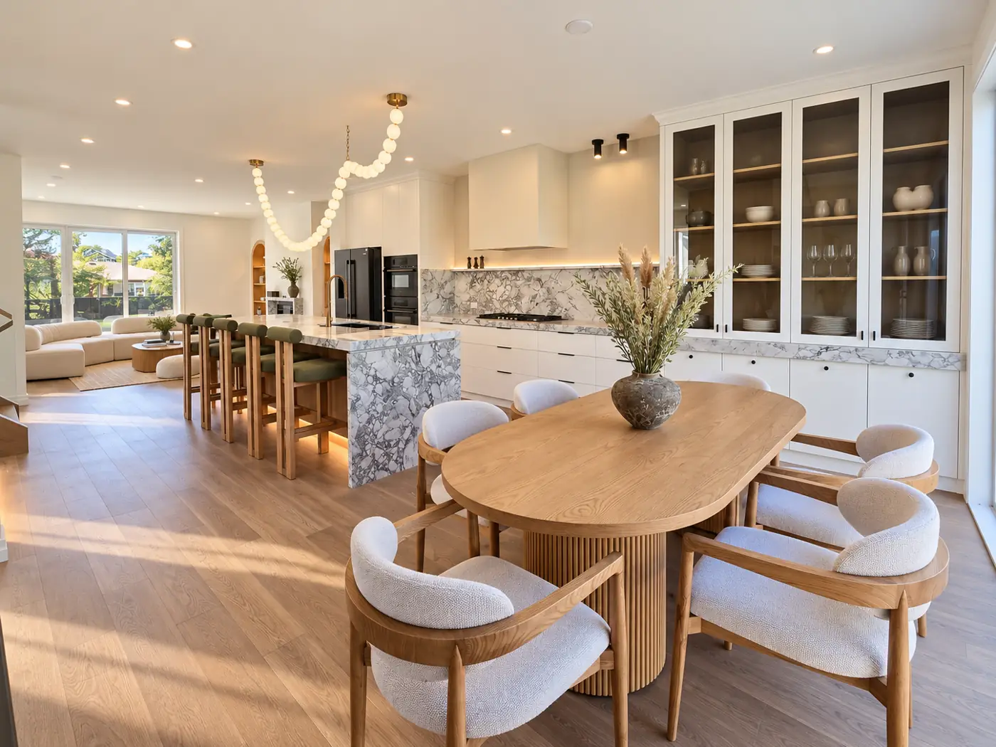 Kitchen, furnished: the run, the island and the dining table from the far end