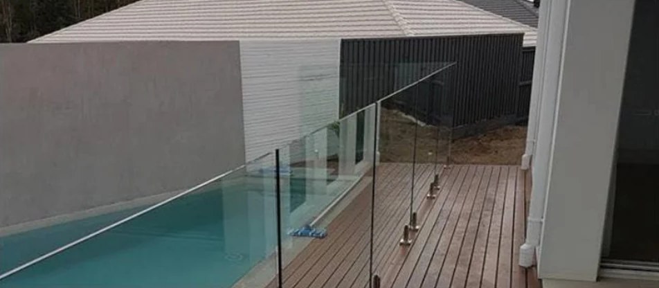 Frameless glass pool fence along a timber deck